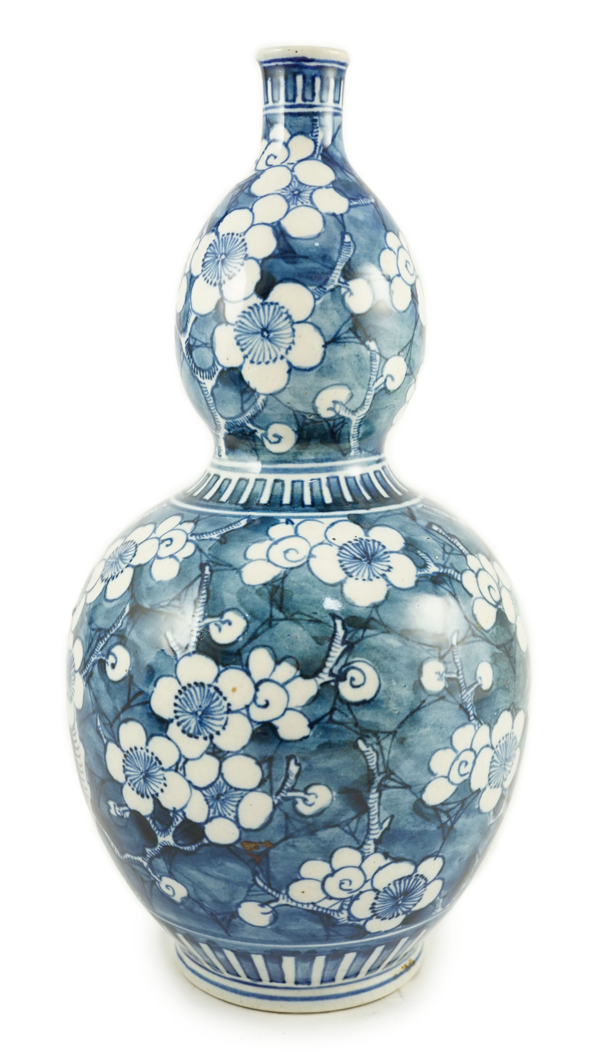 A Japanese blue and white 'prunus' double gourd sake flask, late Edo period, height 32cms 31.5cm high